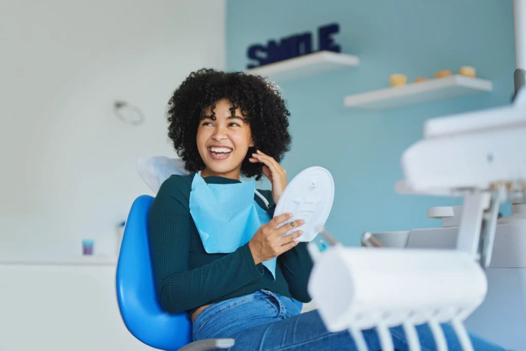 a very photogenic patient smiling in a dental office